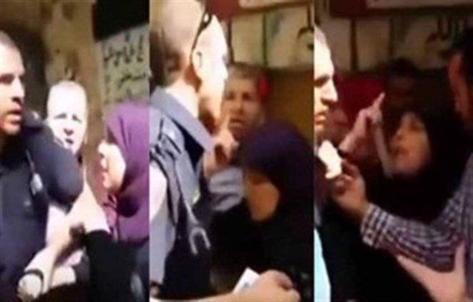 بالفيديو.. امرأة شجاعة تمنع شرطيا إسرائيليا من القبض على فتاة فلسطينية