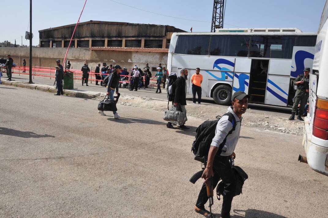 بالصور.. خروج الدفعة السابعة للمسلحين من حي الوعر بحمص