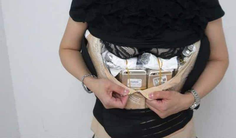 بالصور.. صينية حاولت تهريب أكثر من 100 آيفون داخل ملابسها