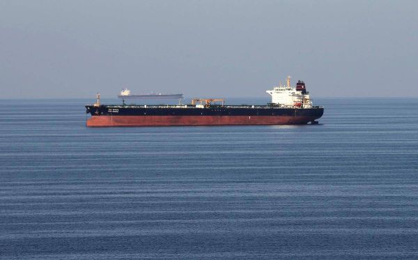 Oil edges higher on Venezuela turmoil, but weighed by U.S. crude stock build